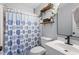 This bathroom features wood shelves, sink, toilet and shower/bath at 1752 Cobblestone Dr, Creedmoor, NC 27522