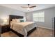 Bedroom featuring a ceiling fan, comfy carpet, bed and bedside table at 1752 Cobblestone Dr, Creedmoor, NC 27522