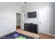 Bedroom features gray walls, carpet flooring, ceiling fan, tv, and a closet at 1752 Cobblestone Dr, Creedmoor, NC 27522