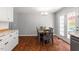 Cozy dining area off the kitchen with hardwood floors and access to the outdoor deck at 1752 Cobblestone Dr, Creedmoor, NC 27522