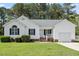 Charming single-story home featuring well-maintained landscaping and an attached garage, nestled among mature trees at 1752 Cobblestone Dr, Creedmoor, NC 27522