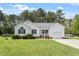Charming white home with manicured lawn, attached garage, and welcoming front porch at 1752 Cobblestone Dr, Creedmoor, NC 27522