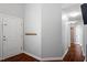 Hallway with hardwood floors leads to additional rooms in the house at 1752 Cobblestone Dr, Creedmoor, NC 27522