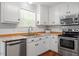 Well-lit kitchen features stainless steel appliances and white cabinetry at 1752 Cobblestone Dr, Creedmoor, NC 27522