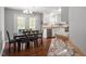 Open concept kitchen and dining area features a view of the deck and stainless appliances at 1752 Cobblestone Dr, Creedmoor, NC 27522