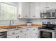 This bright kitchen features white cabinets, stainless appliances, and butcher block countertops at 1752 Cobblestone Dr, Creedmoor, NC 27522