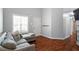 Cozy living room showcases stylish decor, natural light, and sleek wood floors, with a view of the entry door at 1752 Cobblestone Dr, Creedmoor, NC 27522