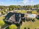 Overhead view of a community pool area with sun shelters, clubhouse, landscaping, and surrounding homes at 1840 Flint Valley Ln, Apex, NC 27502