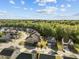 An aerial shot reveals a community with tree-lined streets, lush lawns, and a variety of home styles at 1840 Flint Valley Ln, Apex, NC 27502