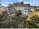 Exterior shot showcasing a multi-story home with a wooden deck, a spacious yard, and neighboring houses in the background at 1840 Flint Valley Ln, Apex, NC 27502
