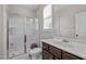 Bathroom featuring a glass-enclosed shower, white fixtures, and dark wood vanity with a sink at 1840 Flint Valley Ln, Apex, NC 27502