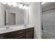 Bathroom features a double sink vanity with dark cabinets, and a shower and tub combination at 1840 Flint Valley Ln, Apex, NC 27502