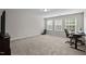 Spacious bedroom area with three large windows offering an abundance of natural light and neutral colored walls at 1840 Flint Valley Ln, Apex, NC 27502