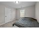 This bedroom features a neutral color palette, carpeted floor and a source of natural light at 1840 Flint Valley Ln, Apex, NC 27502