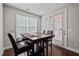 Bright breakfast nook with a wooden table, four chairs, and access to the outdoor patio through French doors at 1840 Flint Valley Ln, Apex, NC 27502