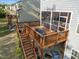 Multi-tiered wooden deck complete with a screened in porch, staircase, and furniture at 1840 Flint Valley Ln, Apex, NC 27502
