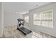 This exercise room features a treadmill, stationary bike and plenty of natural light at 1840 Flint Valley Ln, Apex, NC 27502