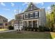 Charming two-story home with a well-manicured lawn, two-car garage, and inviting front porch at 1840 Flint Valley Ln, Apex, NC 27502