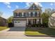 Charming two-story home with a well-manicured lawn, two-car garage, and inviting front porch at 1840 Flint Valley Ln, Apex, NC 27502