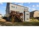 Exterior side-view of a house featuring a wooden deck with access to the backyard at 1840 Flint Valley Ln, Apex, NC 27502
