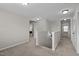 Upstairs hallway featuring neutral paint, plush carpet and a view into another room at 1840 Flint Valley Ln, Apex, NC 27502