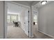 View of an open hallway with a home office and bedroom with natural light and neutral-colored walls and carpeting at 1840 Flint Valley Ln, Apex, NC 27502