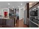 Well-equipped kitchen with granite countertops, stainless steel appliances, dark cabinets and an open layout at 1840 Flint Valley Ln, Apex, NC 27502