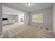 A spacious carpeted living room offering ample natural light from large windows at 1840 Flint Valley Ln, Apex, NC 27502