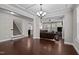 Open-concept living room with hardwood floors, coffered ceilings, and views to a cozy sitting room at 1840 Flint Valley Ln, Apex, NC 27502