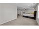 Spacious main bedroom with a decorative tray ceiling, ceiling fan, large bed, and lots of natural light at 1840 Flint Valley Ln, Apex, NC 27502
