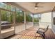 Inviting screened porch with wood flooring, a ceiling fan, and views of the green backyard at 1840 Flint Valley Ln, Apex, NC 27502