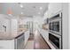Modern kitchen featuring stainless steel appliances, granite countertops and white cabinetry at 190 Bingham Creek Dr, Garner, NC 27529