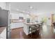 Bright, modern kitchen with a large island, stainless steel appliances, and a dining area at 190 Bingham Creek Dr, Garner, NC 27529