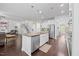 Modern kitchen featuring stainless steel appliances, granite countertops, island and white cabinetry at 190 Bingham Creek Dr, Garner, NC 27529