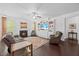 Cozy living room featuring a fireplace, hardwood floors, ceiling fan, and built-in shelving at 190 Bingham Creek Dr, Garner, NC 27529