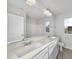 This bathroom features a dual sink vanity, large mirror, and a window at 20 Carolina Maple Dr, Franklinton, NC 27525