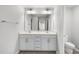 Bright bathroom featuring a double vanity, a large mirror, and ceramic floors at 20 Carolina Maple Dr, Franklinton, NC 27525