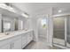 Bright bathroom with a double vanity, a large mirror, and a glass-enclosed shower at 20 Carolina Maple Dr, Franklinton, NC 27525