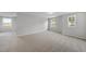 An empty bedroom with neutral walls and carpet, and three large windows at 20 Carolina Maple Dr, Franklinton, NC 27525