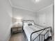 Well-lit bedroom with a metal frame bed, soft carpet, and a window that provides natural light at 20 Carolina Maple Dr, Franklinton, NC 27525