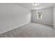 An empty bedroom features neutral carpet and white walls with a window at 20 Carolina Maple Dr, Franklinton, NC 27525
