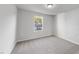 An empty bedroom with neutral walls and carpet featuring a single window at 20 Carolina Maple Dr, Franklinton, NC 27525