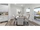 Cozy dining area with a round wood table, surrounded by cushioned chairs and two large windows offering ample light at 20 Carolina Maple Dr, Franklinton, NC 27525