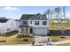 Charming two-story home with a two-car garage, neatly landscaped front yard, and a combination of siding at 20 Carolina Maple Dr, Franklinton, NC 27525