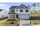 Charming two-story home with a well-manicured lawn, a two-car garage, and inviting curb appeal at 20 Carolina Maple Dr, Franklinton, NC 27525