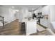 Bright kitchen with white cabinets, stainless steel appliances, and a center island with bar seating. Modern design elements at 20 Carolina Maple Dr, Franklinton, NC 27525