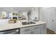 Open concept kitchen featuring an island sink with stone countertops and modern appliances, connecting seamlessly to the living room at 20 Carolina Maple Dr, Franklinton, NC 27525