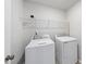 This laundry room contains a large dryer and washing machine and wire shelving at 20 Carolina Maple Dr, Franklinton, NC 27525