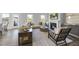 Comfortable living room with a fireplace, a plush sofa and many windows offering natural light at 20 Carolina Maple Dr, Franklinton, NC 27525