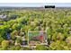 Aerial view of neighborhood close to Downtown Cary, surrounded by mature trees and lush landscape at 201 Dunhagan Pl, Cary, NC 27511